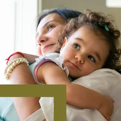 Caregiver and child hugging.