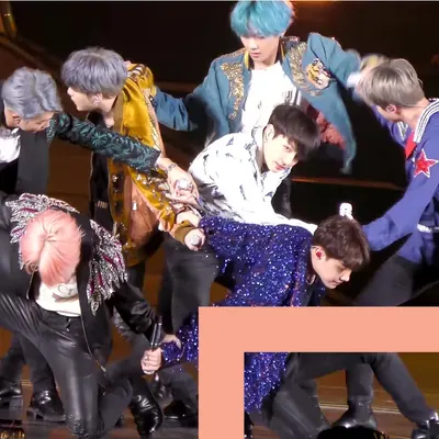 A K-pop Boy Band gathers on stage.