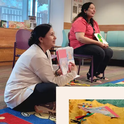 Two women read to children.