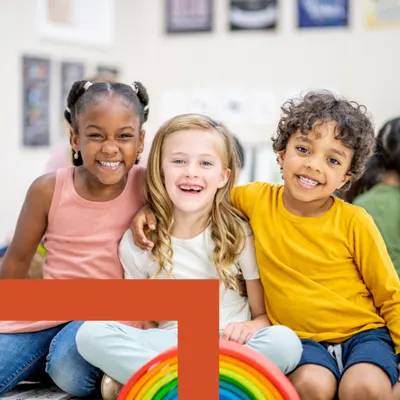 Kids smile at the camera.